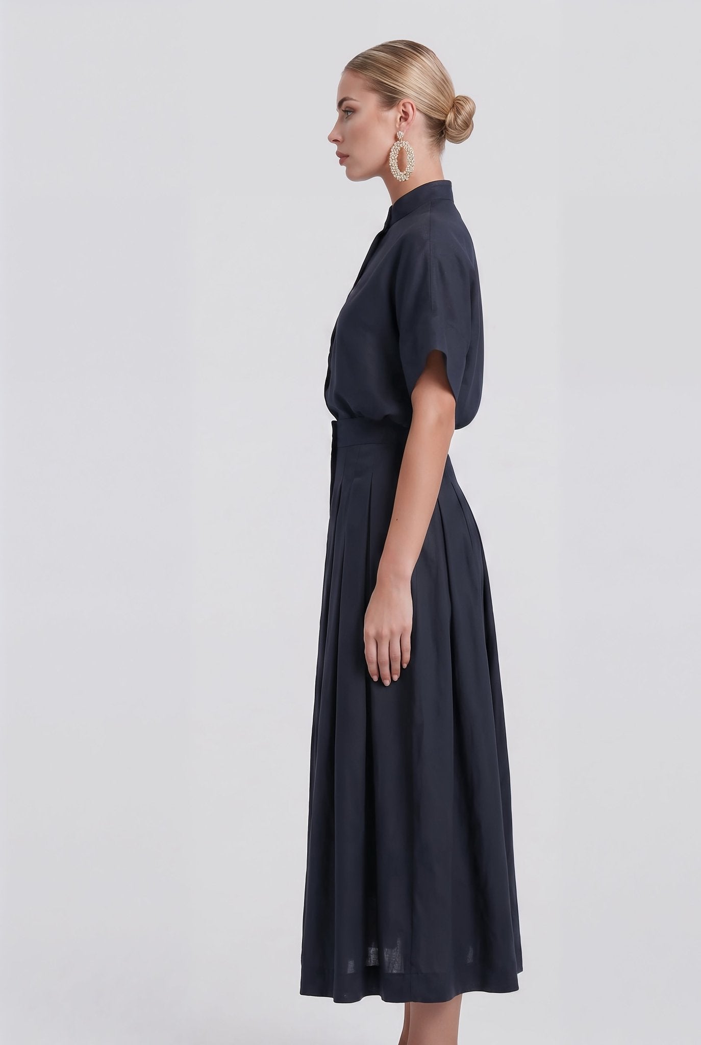 Woman wearing a dark blue dress on a white background