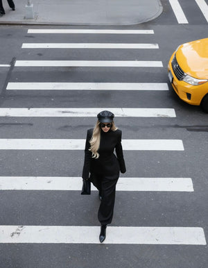 Top-down view of a woman walking across a zebra crossing , dressed in the Metropolis Set – Noir Authority
