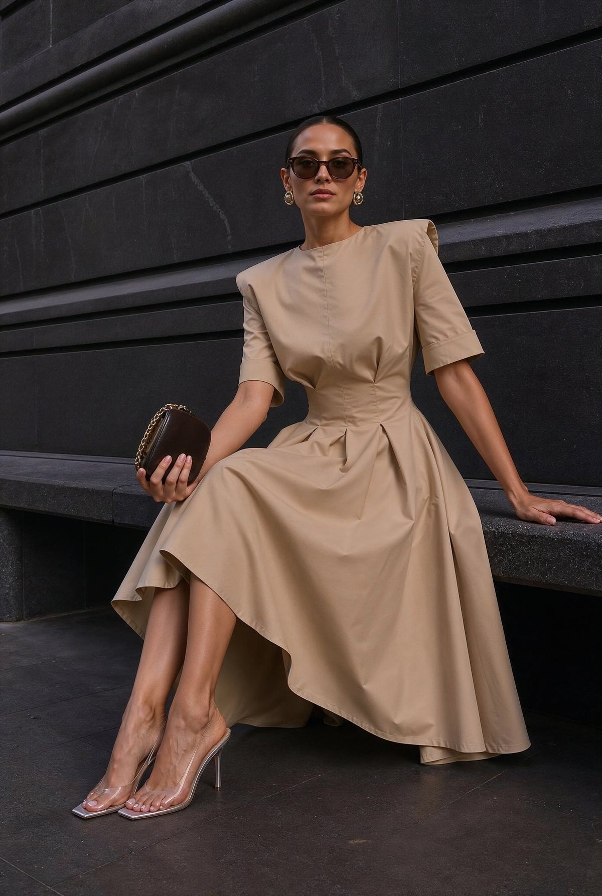 Audrey beige high-low dress with fitted waist and pleated skirt, seated view