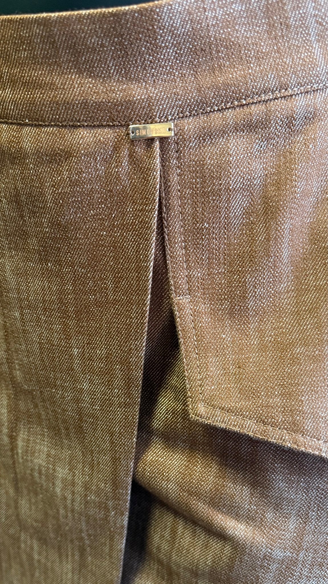 Close-up of Margot skirt’s brown denim, sculpted hip flap and front slit