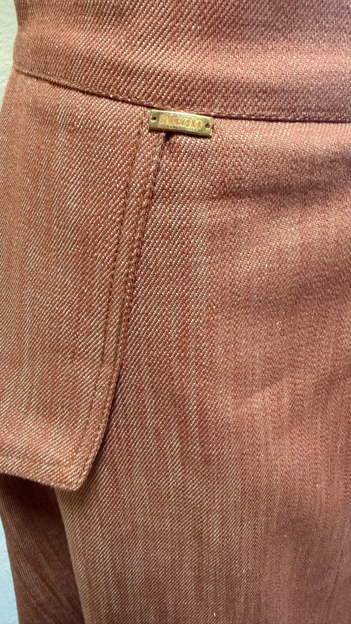 Close-up of Margot skirt’s waistband, denim texture and sculpted hip flap