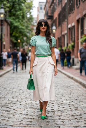 Margot pastel peach denim midi skirt with sculpted hip panels, walking view